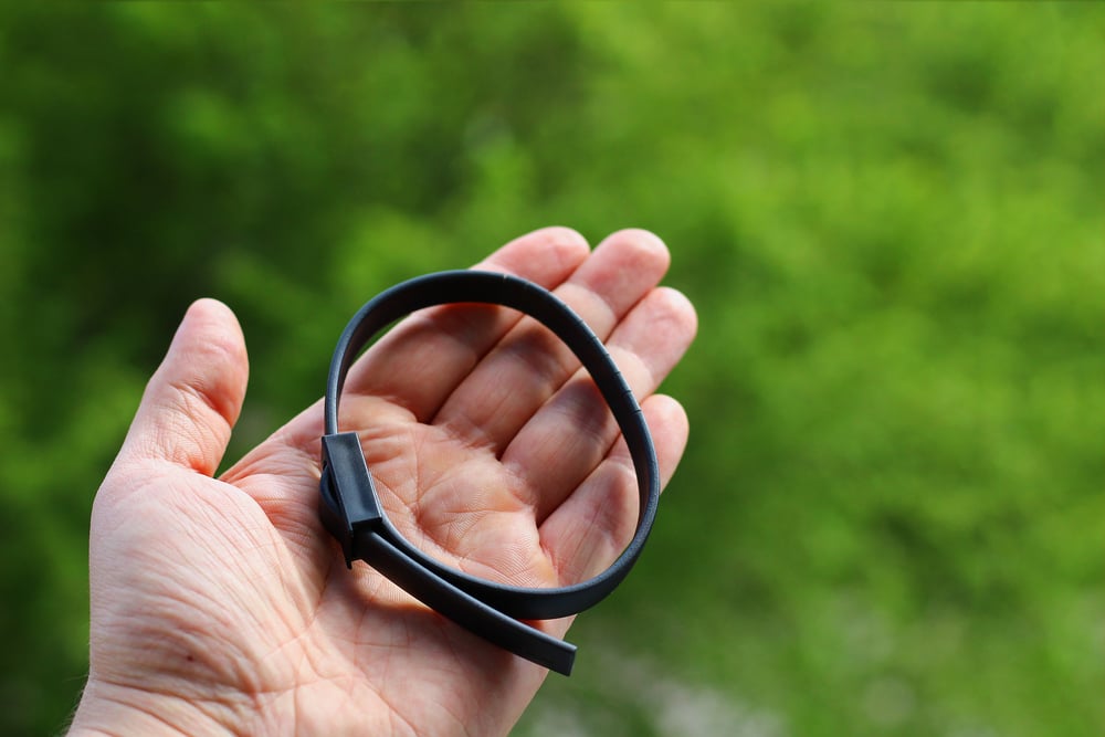 person holding a flea & tick collar
